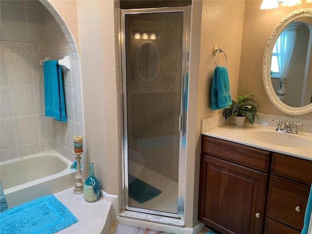 21460 Sheldon Ave, Port Charlotte, FL 33952 - bathroom featuring a tile shower, vanity, tile patterned floors, a bath, and a textured wall