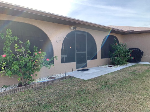 21460 Sheldon Ave, Port Charlotte, FL 33952 - rear view of house featuring a lawn and stucco siding