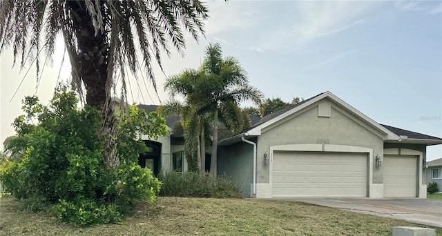 2143 Santonian Ter, North Port, FL 34286 - view of front of house featuring stucco siding, a garage, and concrete driveway
