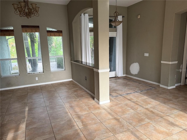 2143 Santonian Ter, North Port, FL 34286 - spare room with arched walkways, light tile patterned floors, and a chandelier