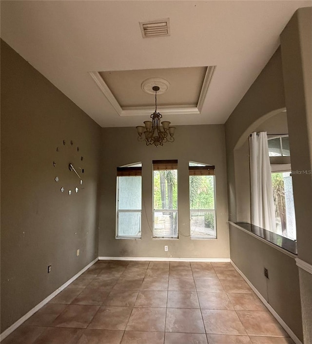 2143 Santonian Ter, North Port, FL 34286 - tiled spare room featuring a raised ceiling, healthy amount of natural light, and a chandelier