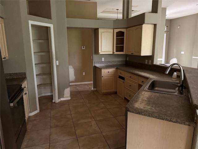 2143 Santonian Ter, North Port, FL 34286 - kitchen with stove, dark countertops, tile patterned floors, and light brown cabinetry