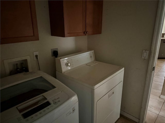 2143 Santonian Ter, North Port, FL 34286 - laundry area featuring washer and clothes dryer, cabinet space, and light tile patterned floors