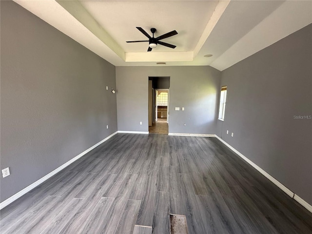 2143 Santonian Ter, North Port, FL 34286 - empty room with a tray ceiling, a ceiling fan, and dark wood-style flooring