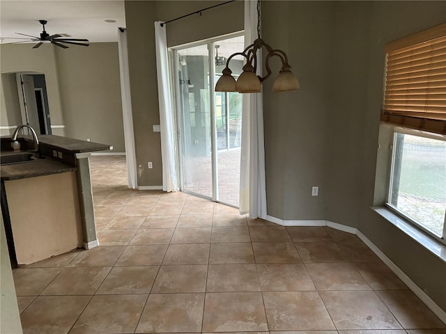 2143 Santonian Ter, North Port, FL 34286 - unfurnished dining area with light tile patterned flooring, a ceiling fan, and arched walkways