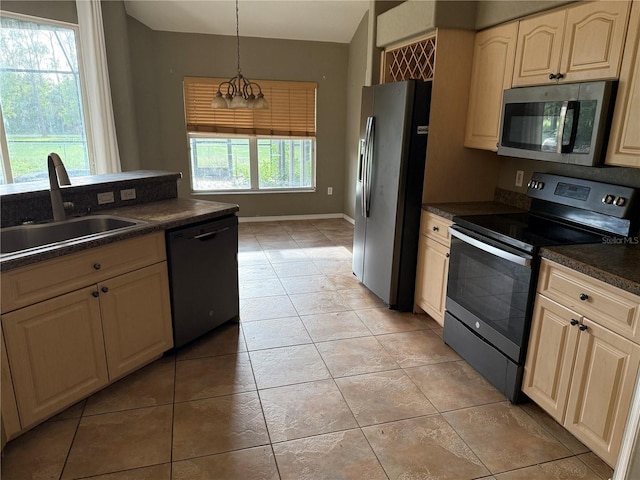 2143 Santonian Ter, North Port, FL 34286 - kitchen featuring stainless steel appliances, dark countertops, light tile patterned flooring, and pendant lighting