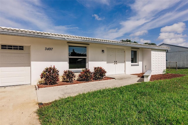 3497 Cohoes St, Port Charlotte, FL 33952 - view of front facade featuring stucco siding, an attached garage, and a front lawn