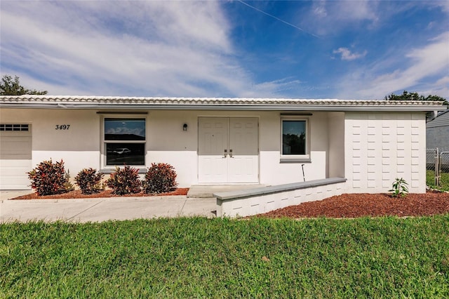 3497 Cohoes St, Port Charlotte, FL 33952 - single story home with stucco siding, a garage, and a front lawn