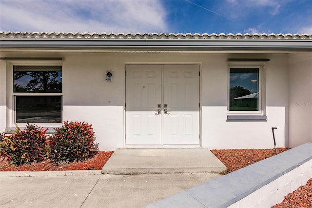 3497 Cohoes St, Port Charlotte, FL 33952 - doorway to property featuring stucco siding