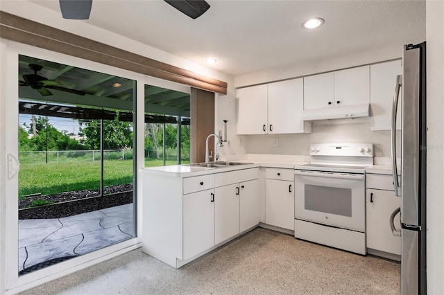 3497 Cohoes St, Port Charlotte, FL 33952 - kitchen with white range with electric cooktop, under cabinet range hood, freestanding refrigerator, white cabinets, and light countertops