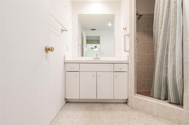 3497 Cohoes St, Port Charlotte, FL 33952 - bathroom with a tile shower, vanity, and speckle patterned floor