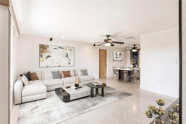 3497 Cohoes St, Port Charlotte, FL 33952 - living area featuring speckle patterned floor, ceiling fan, and recessed lighting