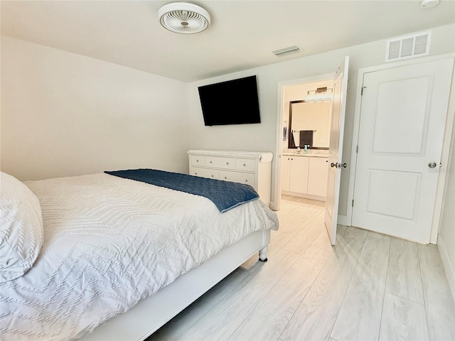 17344 York Ave, Port Charlotte, FL 33948 - bedroom featuring light wood-style flooring and ensuite bathroom
