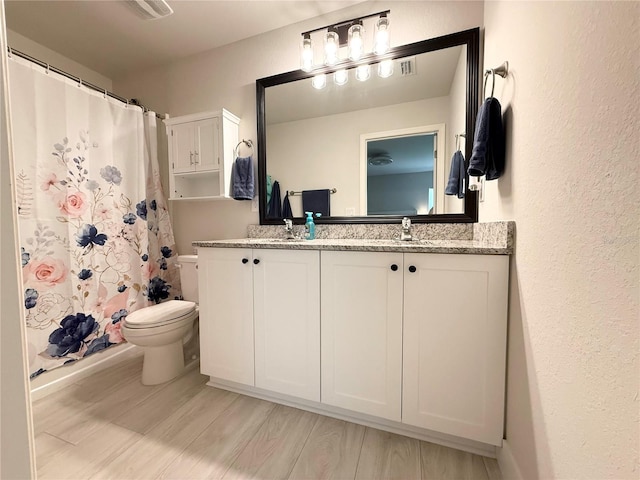 17344 York Ave, Port Charlotte, FL 33948 - bathroom featuring double vanity, a shower with curtain, wood finished floors, and a textured wall