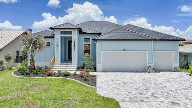 2815 Coral Way, Punta Gorda, FL 33950 - view of front of property with a garage, a standing seam roof, decorative driveway, a metal roof, and stucco siding