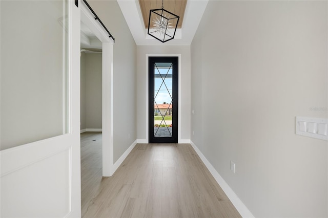 2815 Coral Way, Punta Gorda, FL 33950 - entryway featuring a barn door, light wood-style flooring, and a chandelier