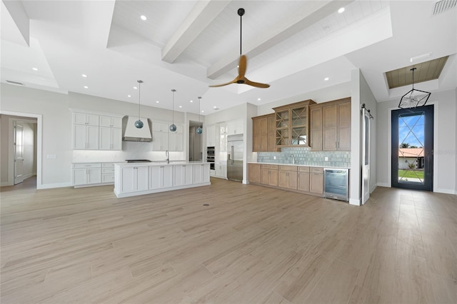 2815 Coral Way, Punta Gorda, FL 33950 - kitchen featuring built in refrigerator, beverage cooler, premium range hood, open floor plan, and backsplash