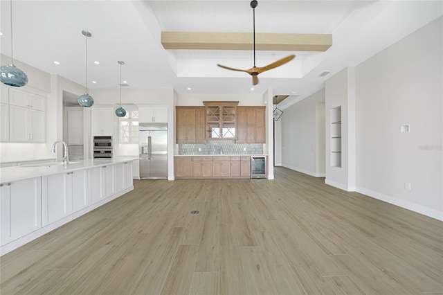 2815 Coral Way, Punta Gorda, FL 33950 - kitchen with appliances with stainless steel finishes, beverage cooler, light countertops, light wood-style flooring, and beam ceiling