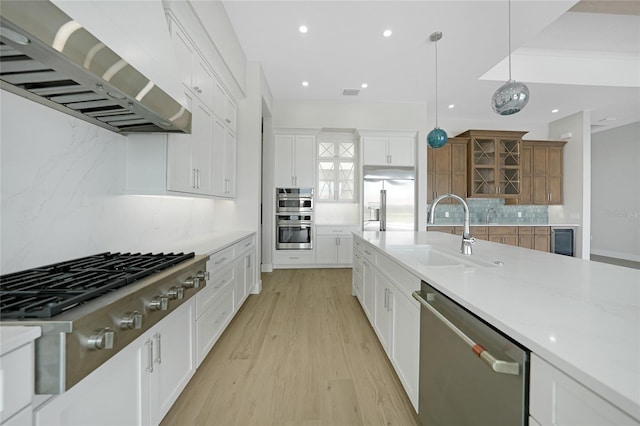 2815 Coral Way, Punta Gorda, FL 33950 - kitchen with appliances with stainless steel finishes, wall chimney exhaust hood, backsplash, light wood-style floors, and recessed lighting