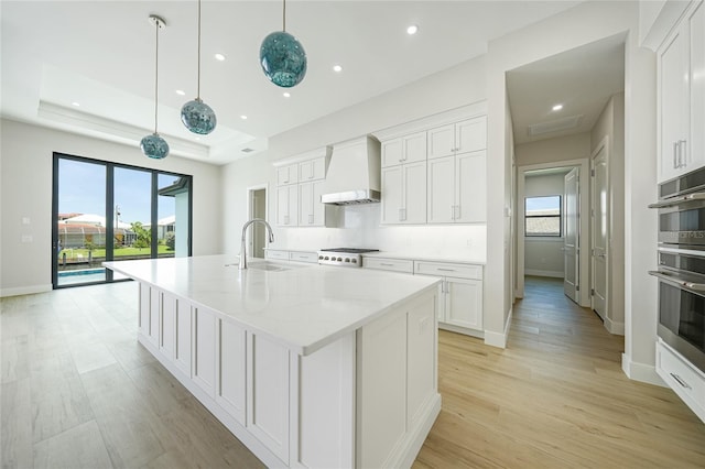 2815 Coral Way, Punta Gorda, FL 33950 - kitchen with custom range hood, white cabinetry, healthy amount of natural light, and recessed lighting