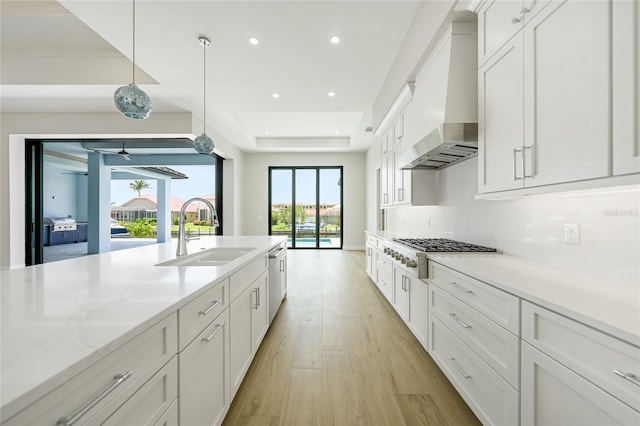 2815 Coral Way, Punta Gorda, FL 33950 - kitchen featuring gas cooktop, light wood-type flooring, white cabinetry, recessed lighting, and custom exhaust hood