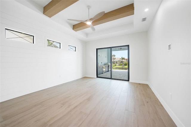 2815 Coral Way, Punta Gorda, FL 33950 - unfurnished room with light wood-style flooring, ceiling fan, and a raised ceiling