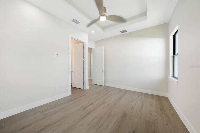 2815 Coral Way, Punta Gorda, FL 33950 - unfurnished bedroom featuring light wood-style flooring, a raised ceiling, ceiling fan, and recessed lighting