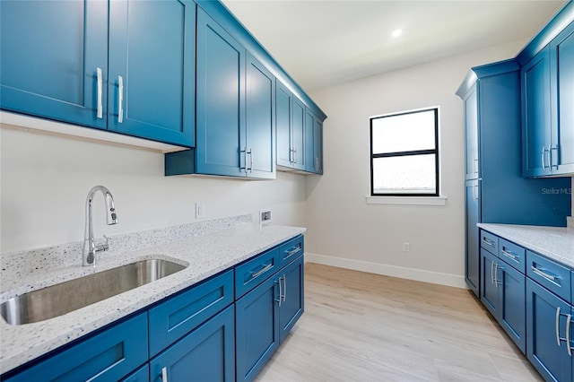 2815 Coral Way, Punta Gorda, FL 33950 - kitchen featuring blue cabinets, light stone counters, light wood finished floors, and recessed lighting