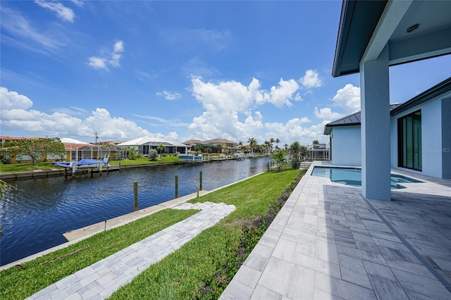 2815 Coral Way, Punta Gorda, FL 33950 - view of green lawn featuring a water view, an outdoor pool, a residential view, a dock, and a patio area