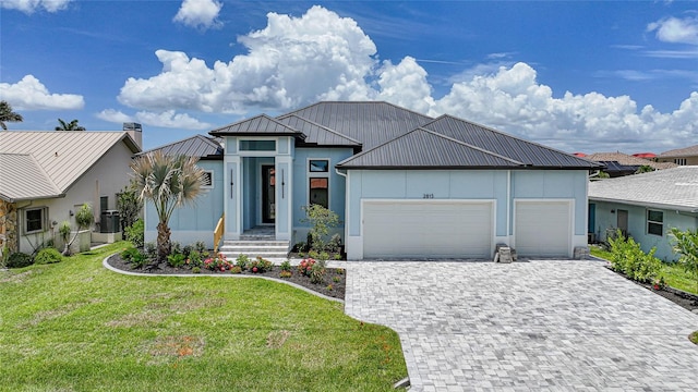 2815 Coral Way, Punta Gorda, FL 33950 - view of front of property featuring a garage, a standing seam roof, a metal roof, and stucco siding