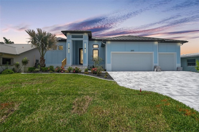 2815 Coral Way, Punta Gorda, FL 33950 - view of front of property featuring a standing seam roof, stucco siding, an attached garage, decorative driveway, and a front yard