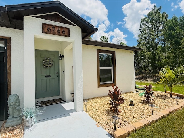 6766 N Pavilion Loop, Citrus Springs, FL 34433 - doorway to property featuring stucco siding