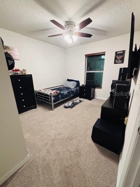 6766 N Pavilion Loop, Citrus Springs, FL 34433 - carpeted bedroom featuring a textured ceiling and a ceiling fan