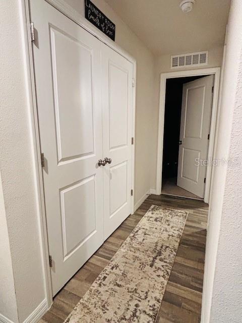 6766 N Pavilion Loop, Citrus Springs, FL 34433 - hallway featuring wood finished floors and baseboards