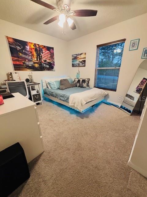 6766 N Pavilion Loop, Citrus Springs, FL 34433 - bedroom with carpet flooring and a ceiling fan