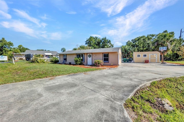 25082 Harborview Rd, Punta Gorda, FL 33980 - single story home featuring stucco siding, a storage unit, driveway, and a front yard