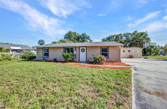 25082 Harborview Rd, Punta Gorda, FL 33980 - ranch-style house featuring a shed, stucco siding, driveway, and a front yard