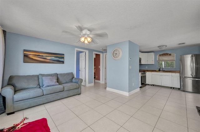 25082 Harborview Rd, Punta Gorda, FL 33980 - living room with light tile patterned floors and a ceiling fan