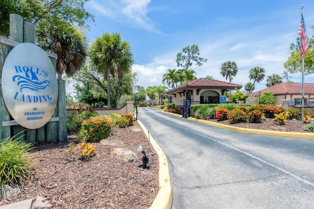 23465 Harborview Rd Unit 1031, Punta Gorda, FL 33980 - view of asphalt street with curbs and a gated entry