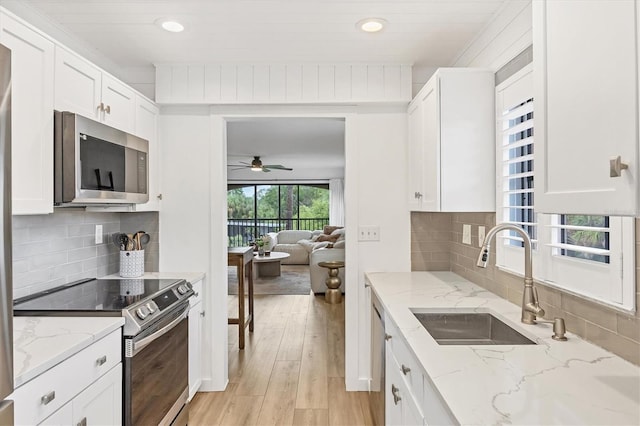 23465 Harborview Rd Unit 1031, Punta Gorda, FL 33980 - kitchen with appliances with stainless steel finishes, light wood-style floors, white cabinetry, ceiling fan, and recessed lighting