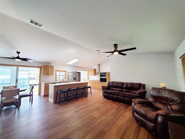 3456 Highlands Rd, Punta Gorda, FL 33983 - living area with a ceiling fan, lofted ceiling, and light wood finished floors