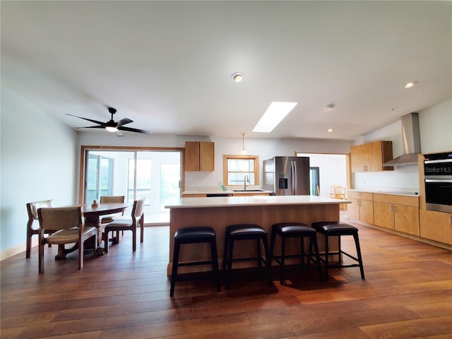 3456 Highlands Rd, Punta Gorda, FL 33983 - kitchen with appliances with stainless steel finishes, wall chimney exhaust hood, a center island, dark wood-style flooring, and recessed lighting