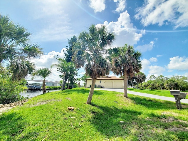3456 Highlands Rd, Punta Gorda, FL 33983 - view of green lawn with driveway and a water view