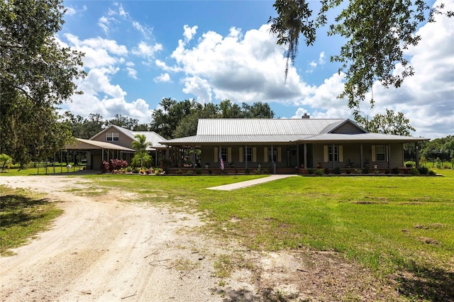 2788 SW County Road 769, Arcadia, FL 34266 - country-style home featuring covered porch, dirt driveway, a front lawn, and a metal roof