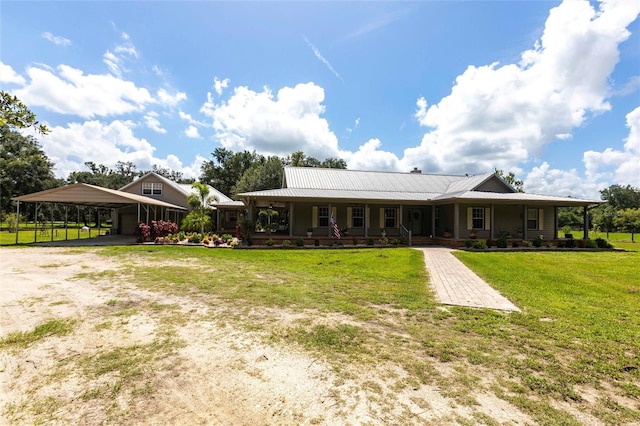 2788 SW County Road 769, Arcadia, FL 34266 - back of property with a porch, a lawn, dirt driveway, an attached carport, and a metal roof