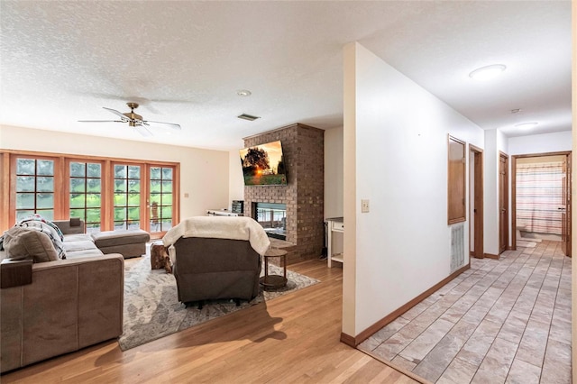 2788 SW County Road 769, Arcadia, FL 34266 - living area featuring a brick fireplace, ceiling fan, and light wood-style floors