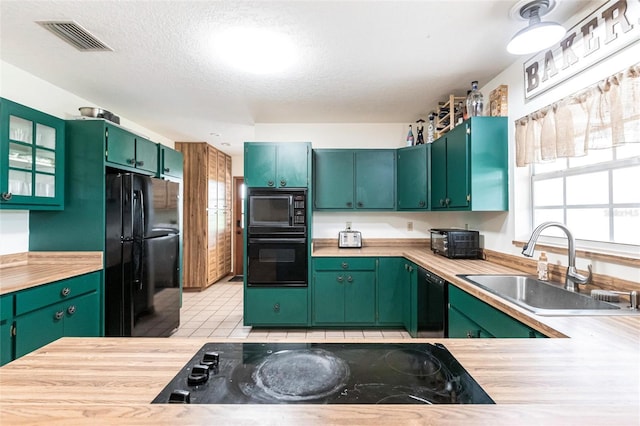 2788 SW County Road 769, Arcadia, FL 34266 - kitchen featuring black appliances, healthy amount of natural light, light countertops, glass insert cabinets, and a textured ceiling