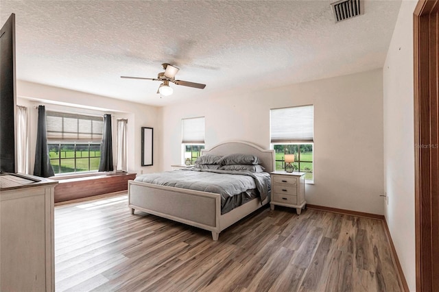 2788 SW County Road 769, Arcadia, FL 34266 - bedroom featuring wood finished floors, a textured ceiling, and a ceiling fan