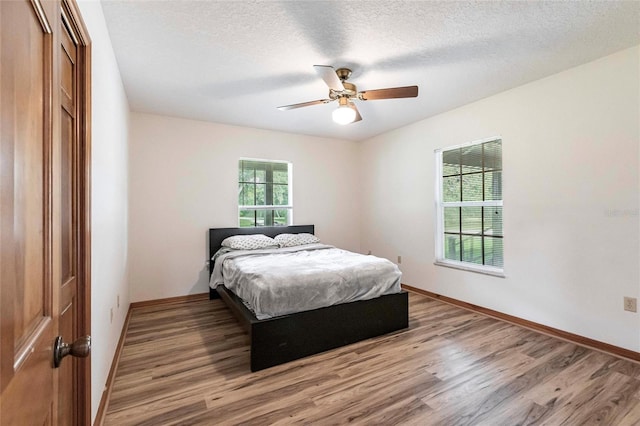 2788 SW County Road 769, Arcadia, FL 34266 - bedroom with wood finished floors, a textured ceiling, and ceiling fan