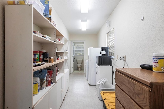 2788 SW County Road 769, Arcadia, FL 34266 - kitchen featuring open shelves, light flooring, a textured wall, white cabinets, and freestanding refrigerator